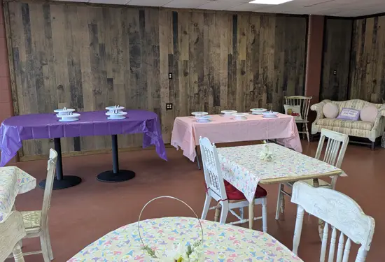 Kozy Cakes party room with decorated tables, pastel tablecloths, and seating for a private event